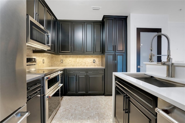 630 Vassar St Unit 2310, Orlando, FL 32804 - kitchen featuring stainless steel appliances, tasteful backsplash, and sink