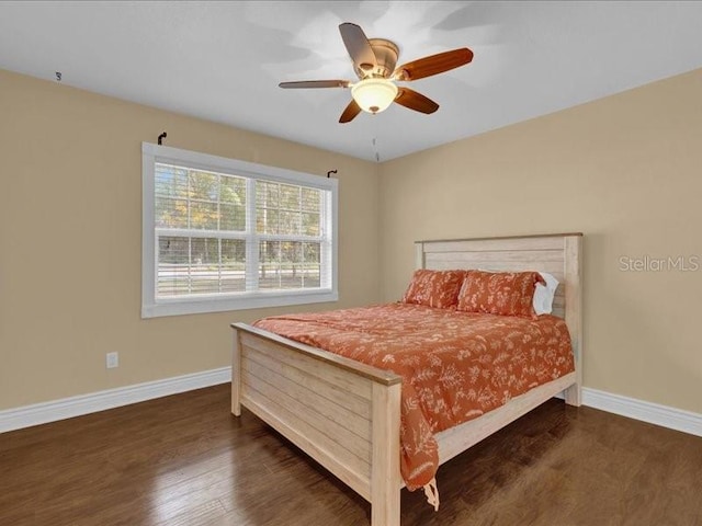 bedroom featuring dark hardwood / wood-style flooring and ceiling fan