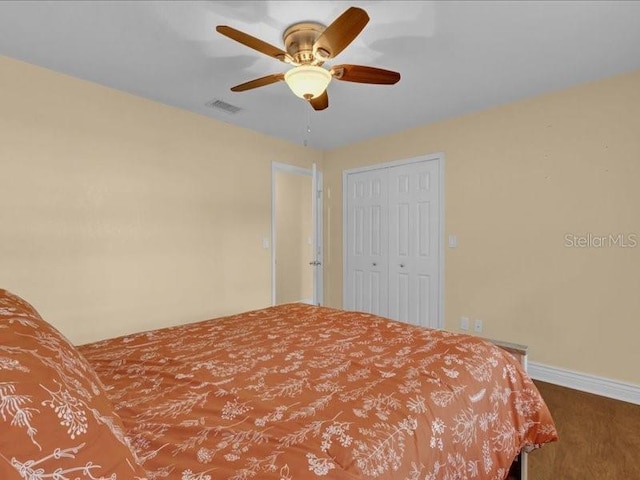 bedroom with ceiling fan and a closet