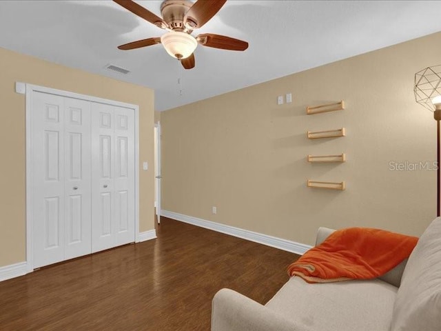 sitting room featuring ceiling fan and dark hardwood / wood-style floors