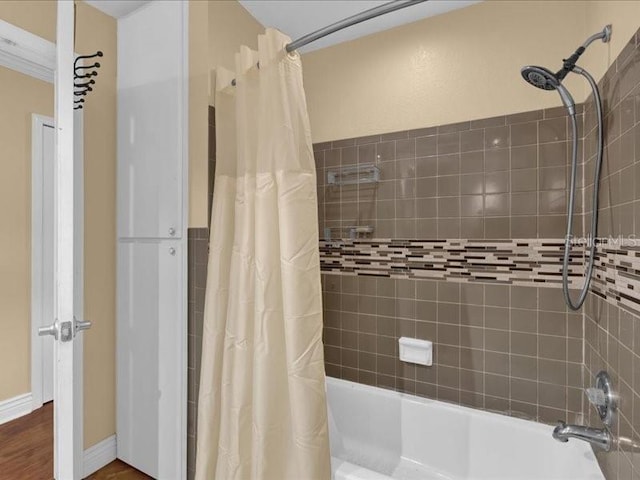 bathroom with shower / tub combo with curtain