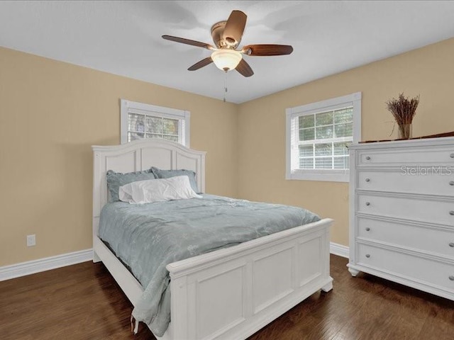 bedroom with dark hardwood / wood-style floors and ceiling fan