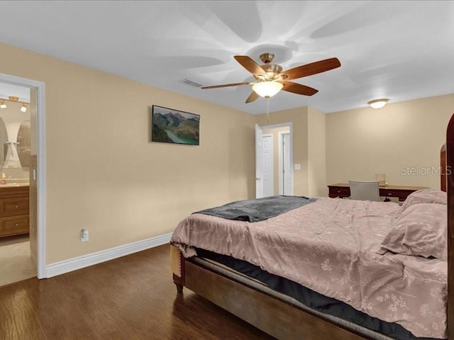 bedroom with ceiling fan, dark hardwood / wood-style floors, and ensuite bath