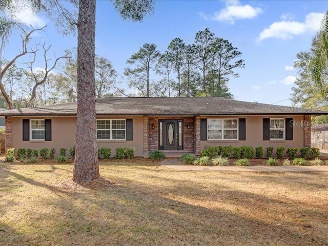 ranch-style home featuring a front yard