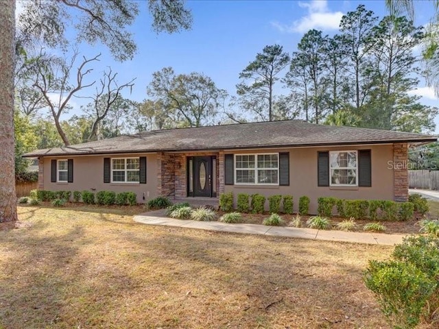 single story home featuring a front yard