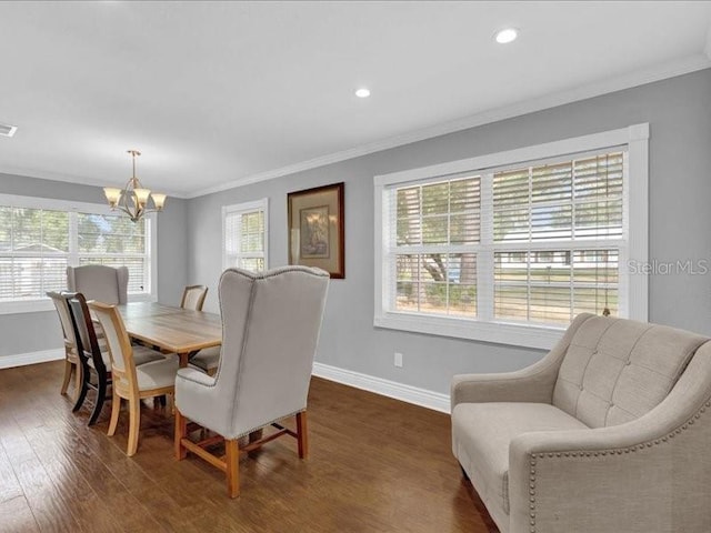 dining area with crown molding, dark wood-type flooring, and an inviting chandelier