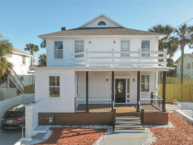 view of front of property featuring a balcony and a porch