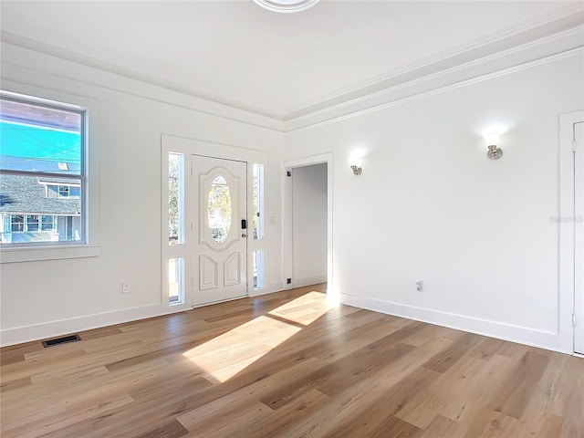 entryway featuring light hardwood / wood-style floors and ornamental molding