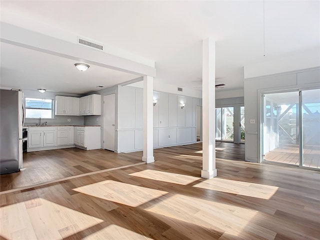 interior space with light hardwood / wood-style flooring, ceiling fan, and sink