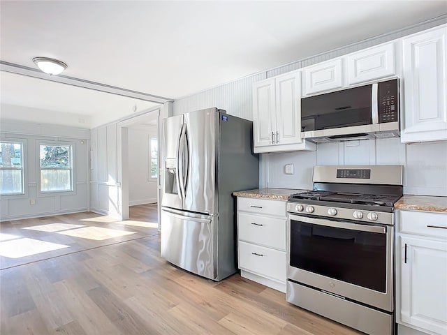 kitchen featuring light hardwood / wood-style floors, white cabinetry, and stainless steel appliances