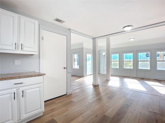 kitchen featuring white cabinets and light hardwood / wood-style floors