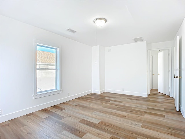 spare room featuring light hardwood / wood-style flooring