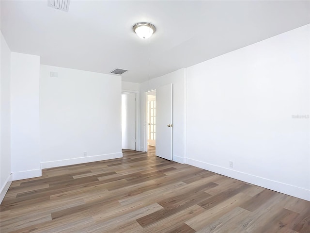 unfurnished room featuring hardwood / wood-style flooring