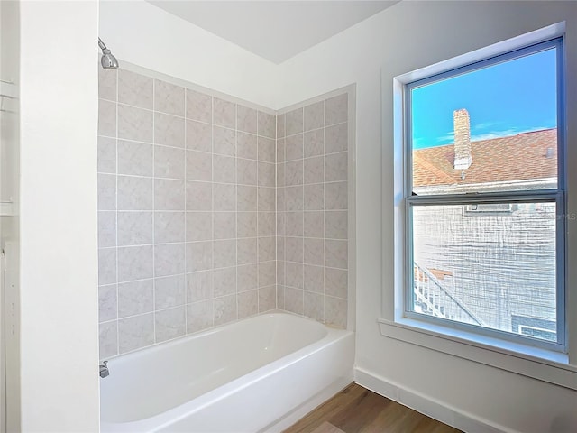 bathroom featuring hardwood / wood-style floors and shower / bathing tub combination