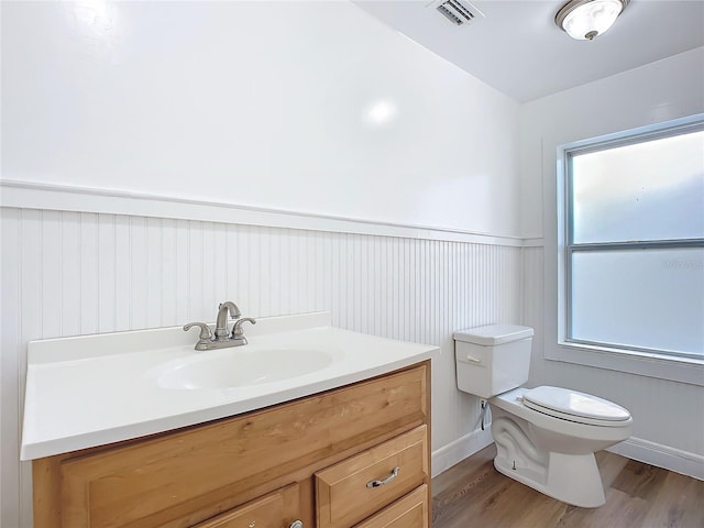 bathroom featuring hardwood / wood-style floors, vanity, and toilet