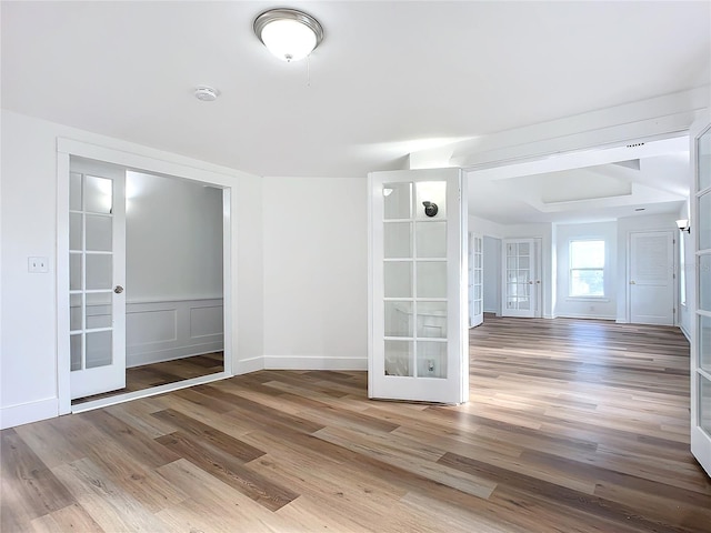 unfurnished room featuring french doors and wood-type flooring