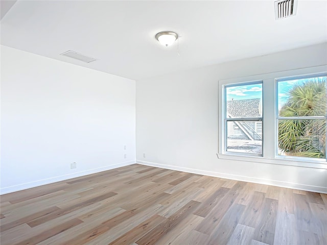 empty room with light hardwood / wood-style floors