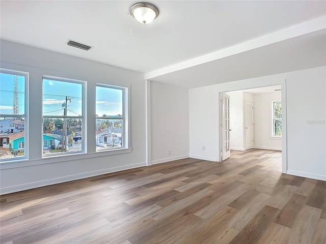 empty room with hardwood / wood-style floors