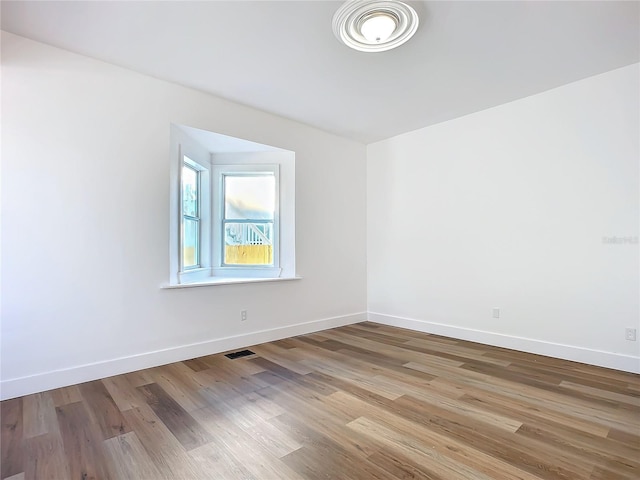 spare room featuring light hardwood / wood-style flooring