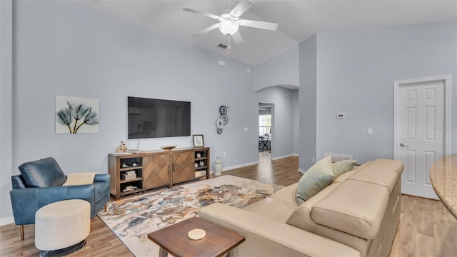 living room featuring ceiling fan, high vaulted ceiling, and light wood-type flooring