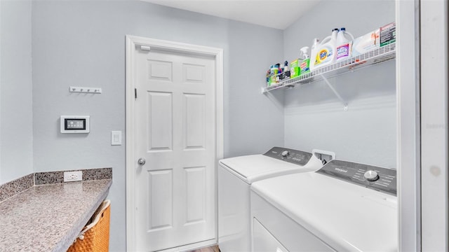 clothes washing area with washer and clothes dryer