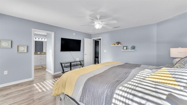 bedroom with ensuite bath, ceiling fan, and light hardwood / wood-style flooring