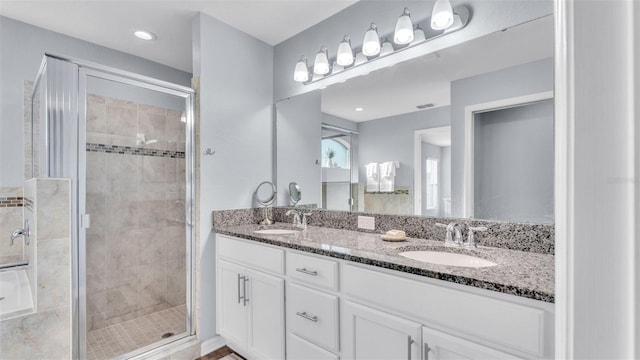 bathroom featuring walk in shower and vanity