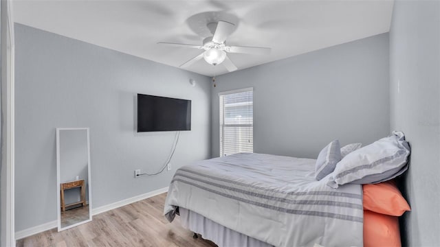 bedroom with ceiling fan and light hardwood / wood-style flooring