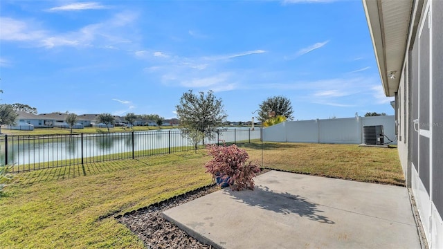 view of yard with a patio area, central AC, and a water view