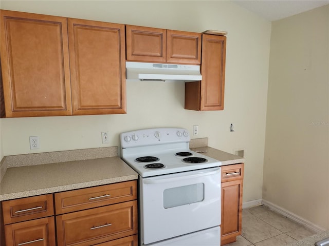 kitchen featuring light tile patterned flooring and white electric stove