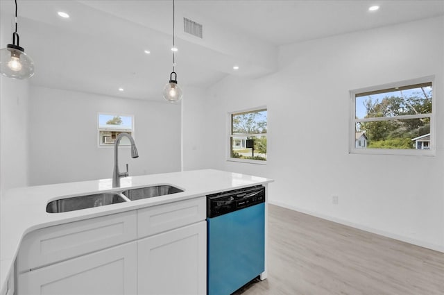 kitchen with dishwasher, white cabinets, hanging light fixtures, and sink