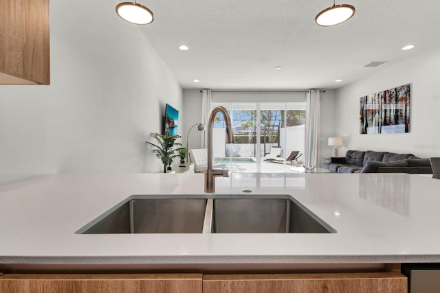 kitchen with sink and a textured ceiling