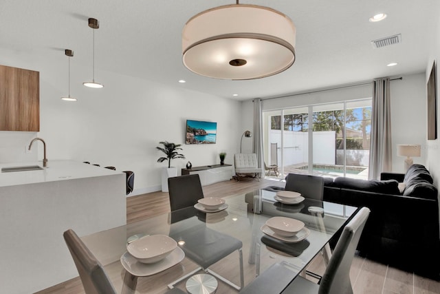 dining room featuring light hardwood / wood-style floors and sink