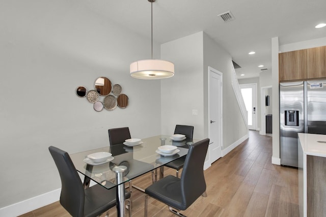 dining area with light hardwood / wood-style floors