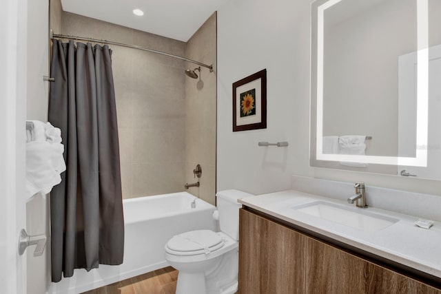 full bathroom featuring hardwood / wood-style flooring, shower / bath combo, toilet, and vanity