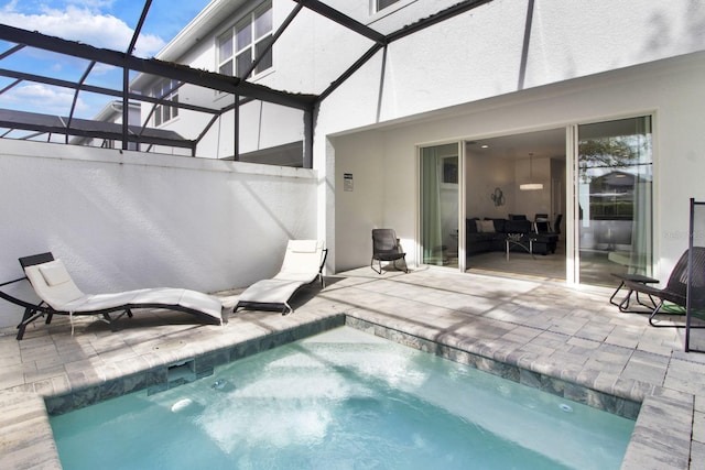 view of pool with a lanai and a patio