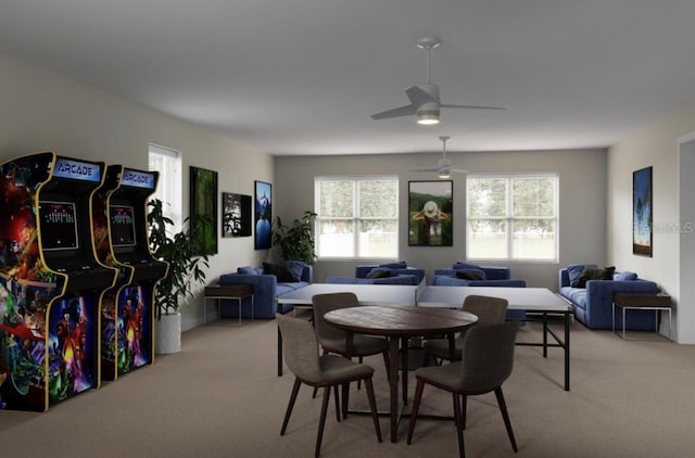 dining room with a wealth of natural light, ceiling fan, and light carpet