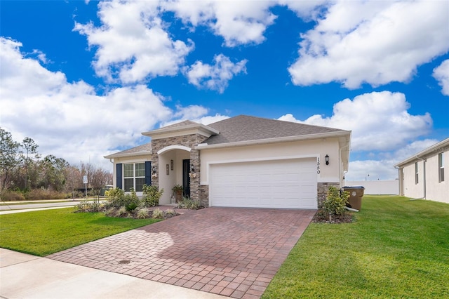 view of front of house featuring a garage and a front lawn