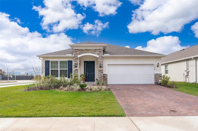 view of front of home with a front lawn and a garage