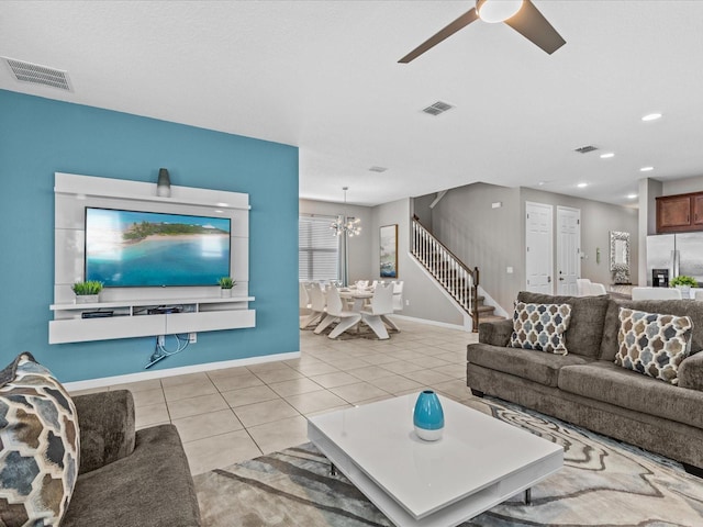 living room with ceiling fan with notable chandelier and light tile patterned flooring