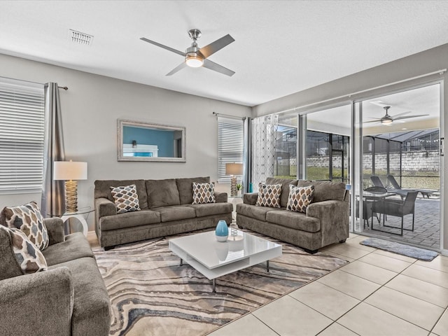 tiled living room with ceiling fan