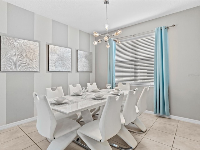 tiled dining space with an inviting chandelier