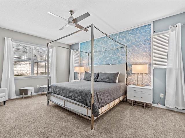 bedroom with a textured ceiling, ceiling fan, and carpet flooring