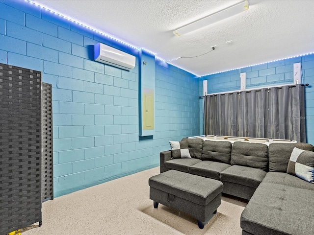 home theater room featuring a textured ceiling and a wall mounted AC