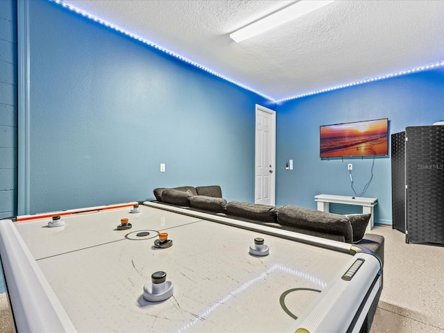 game room with a textured ceiling