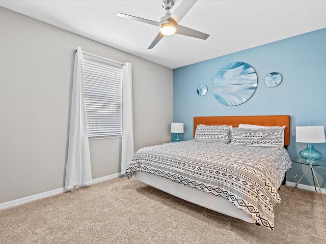 bedroom with carpet flooring, a textured ceiling, and ceiling fan