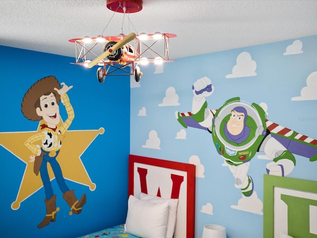 playroom featuring a textured ceiling