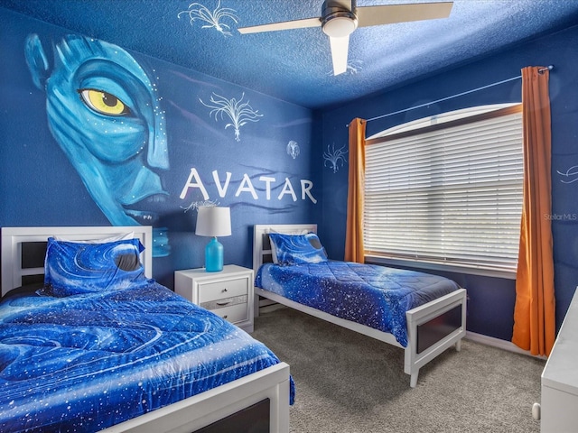 bedroom with ceiling fan, carpet floors, and a textured ceiling