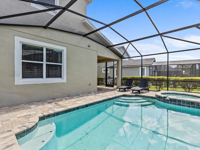 view of swimming pool featuring a lanai, a patio area, and an in ground hot tub