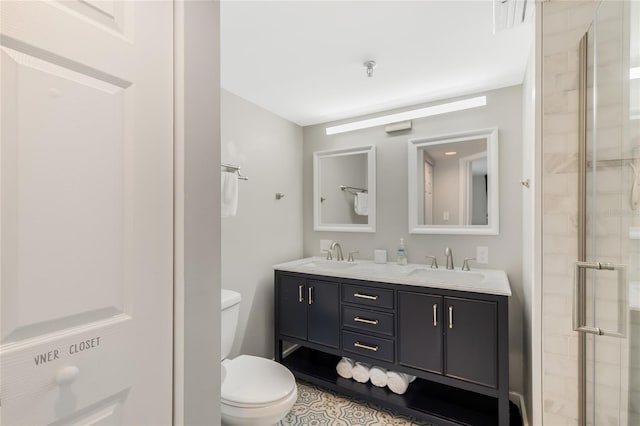 bathroom featuring vanity, an enclosed shower, and toilet